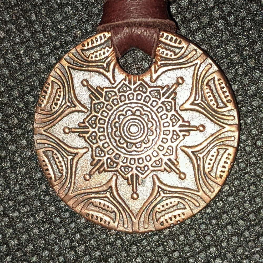 Brass mandala necklace on leather